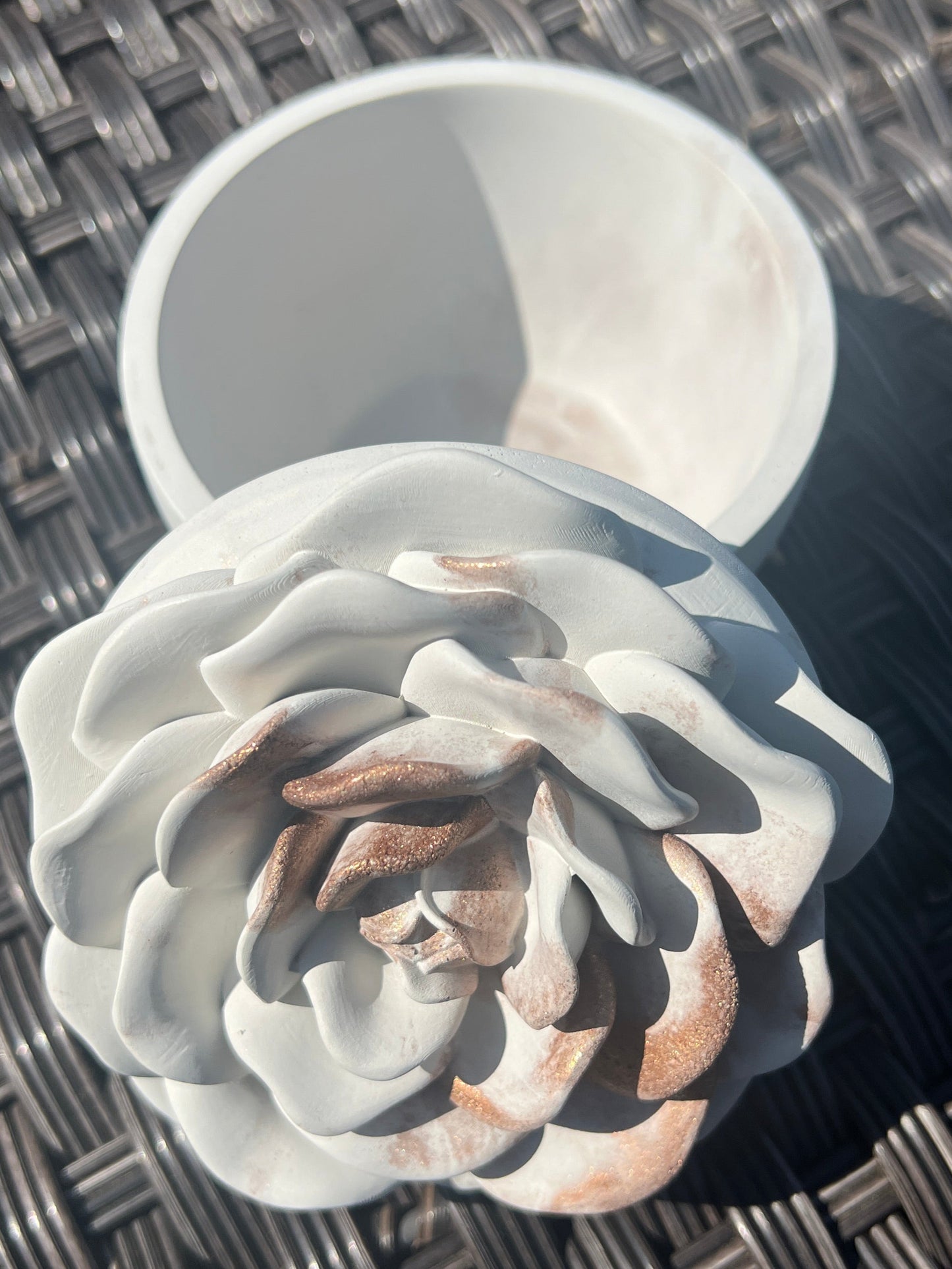 Decorative rose-shaped object on a textured surface