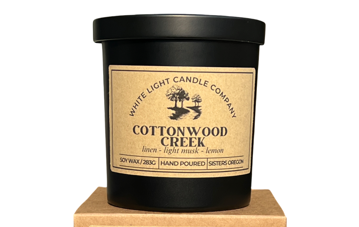 Candle with 'Cottonwood Creek' label on a white background