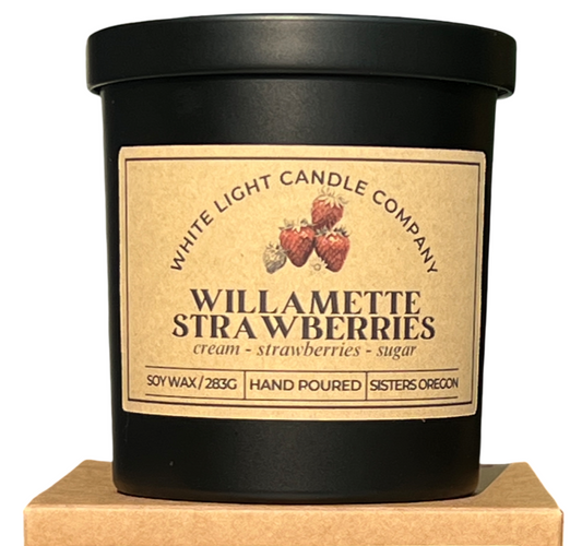 Candle with 'Willamette Strawberries' label on a matching box, featuring White Light Candle Company branding.