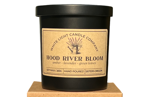 Candle with 'Hood River Bloom' label on a matching box, White Light Candle Company branding.