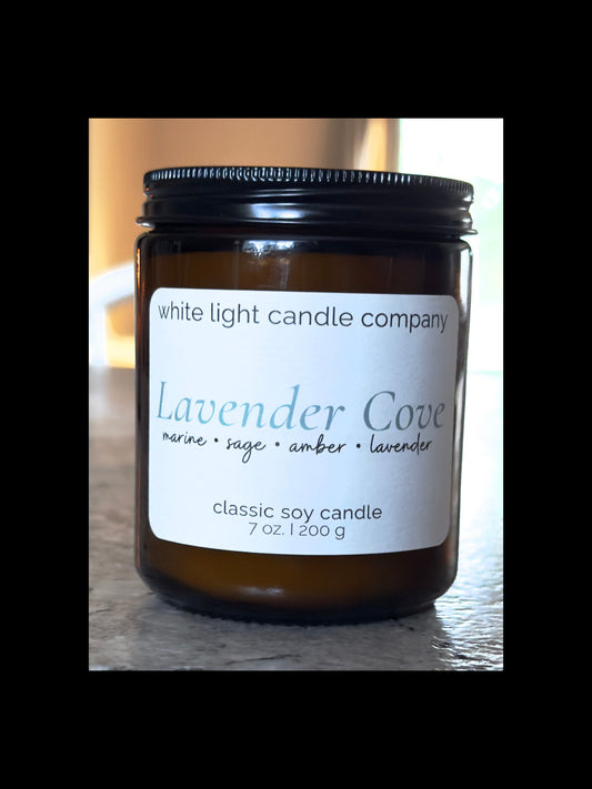 Candle jar with 'White Light Candle Company' label on a wooden surface