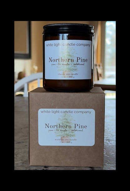 Candle jar and box from White Light Candle Company labeled 'Northern Pine' on a neutral background.